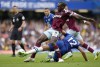 West Ham's Michail Antonio, center, duels for the ball with Chelsea's Ruben Loftus-Cheek during the English Premier League soccer match between Chelsea and West Ham United at Stamford Bridge Stadium in London, Saturday, Sept. 3, 2022. (AP Photo/Kirsty Wigglesworth)