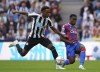 Newcastle United's Joe Willock, left, and Crystal Palace's Marc Guehi battle for the ball during the English Premier League soccer match between Newcastle United and Crystal Palace at St. James' Park, Newcastle, Saturday, Sept. 3, 2022. (Owen Humphreys/PA via AP)