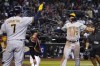 Milwaukee Brewers' Tyrone Taylor (15) celebrates with Esteury Ruiz and Victor Caratini (7) after hitting a two-run home run against the Arizona Diamondbacks during the 10th inning of a baseball game Saturday, Sept. 3, 2022, in Phoenix. The Brewers won 8-6. (AP Photo/Rick Scuteri)