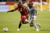 Toronto FC forward Ayo Akinola (20) and CF Montreal defender Rudy Camacho (4) run for the ball during first half MLS soccer action in Toronto on Sunday, Sept. 4, 2022. THE CANADIAN PRESS/Cole Burston