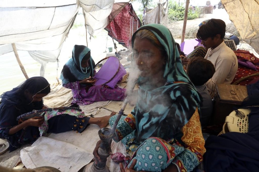 Victims of the unprecedented flooding from monsoon rains take refuge in Jaffarabad, a district of Pakistan's southwestern Baluchistan province, Monday, Sept. 5, 2022. The U.N. refugee agency rushed in more desperately needed aid Monday to flood-stricken Pakistan as the nation's prime minister traveled to the south where rising waters of Lake Manchar pose a new threat. (AP Photo/Fareed Khan)