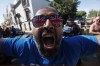 FILE - A Glasgow Ranger supporter cheers in downtown Seville, Spain, on May 17, 2022, prior to the Europa League final between Eintracht Frankfurt and Glasgow Rangers. Scottish soccer giant Rangers is back in the Champions League after a 12-year absence during which the club went out of business because of a financial crisis. Rangers is one of Europe's most storied clubs and has a record 55 national league titles. The Glasgow team has gone through a bruising decade after starting afresh at the bottom of Scotland’s soccer pyramid 10 years ago. (AP Photo/Angel Fernandez)