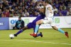 Orlando City's Tesho Akindele, left, attempts a shot on goal as New England Revolution's Henry Kessler defends during the second half of an MLS soccer match Saturday, Aug. 6, 2022, in Orlando, Fla. THE CANADIAN PRESS/AP/John Raoux
