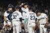 Seattle Mariners catcher Cal Raleigh, pitching coach Pete Woodworth, starting pitcher Logan Gilbert, first baseman Ty France and second baseman Adam Frazier, from left, meet at the mound during the sixth inning of the team's baseball game against the Chicago White Sox, Tuesday, Sept. 6, 2022, in Seattle. (AP Photo/Stephen Brashear)