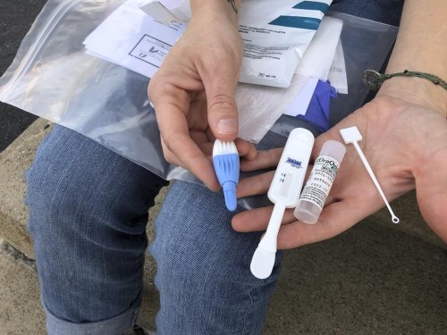 FILE - Solutions Oriented Addiction Response organizer Brooke Parker displays an HIV testing kit in Charleston, W.Va., on March 9, 2021. A federal judge ruled on Wednesday, Sept. 7, 2022, that required coverage of an HIV prevention drug under the Affordable Care Act violates a Texas employer's religious beliefs and undercut the broader system that determines which preventive drugs are covered in the U.S. (AP Photo/John Raby, File)