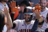 San Francisco Giants' David Villar celebrates his solo home run with teammates in the dugout during the seventh inning of a baseball game against the Los Angeles Dodgers on Wednesday, Sept. 7, 2022, in Los Angeles. (AP Photo/Marcio Jose Sanchez)