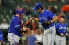 Toronto Blue Jays catcher Alejandro Kirk, left, and relief pitcher Jordan Romano celebrate after defeating the Baltimore Orioles in a baseball game, Wednesday, Sept. 7, 2022, in Baltimore. The Blue Jays won 4-1. THE CANADIAN PRESS/AP -Julio Cortez