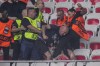 A Nice supporter beats a FC Koln supporters during clashes prior to the start of the Europa Conference League Group D match between OCG Nice and FC Koln at the Allianz Riviera stadium in Nice, France, Thursday, Sept. 8, 2022. (AP Photo/Daniel Cole)