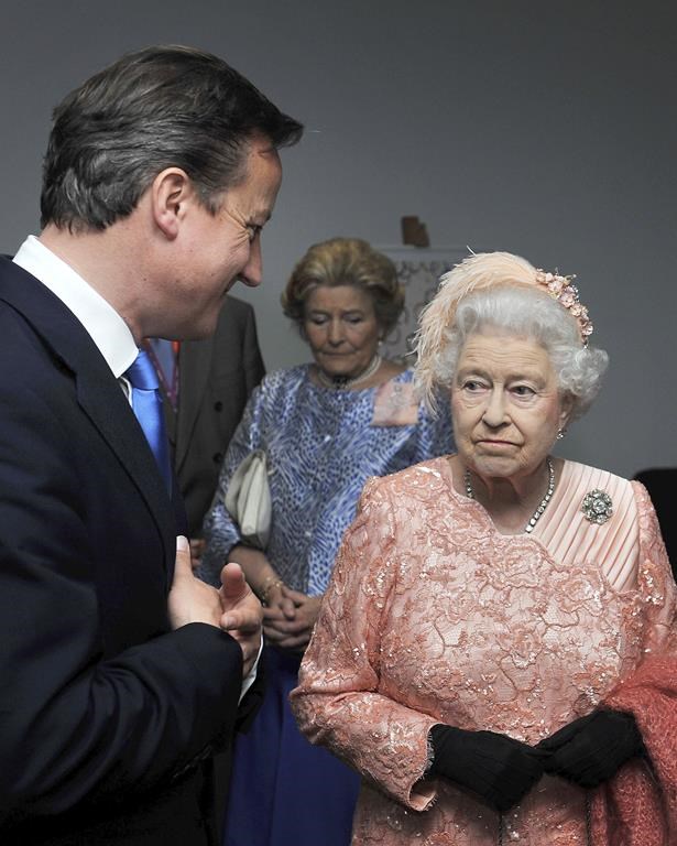 FILE - Britain's Queen Elizabeth II, right, and Prime Minister David Cameron arrive for the Opening Ceremony of the 2012 Olympic Summer Games at the Olympic Stadium in London, Friday, July 27, 2012. In seven decades on the throne, Queen Elizabeth II saw 15 British prime ministers come and go, from Winston Churchill to Margaret Thatcher to Boris Johnson to Liz Truss. (John Stillwell, Pool Photo via AP, File)