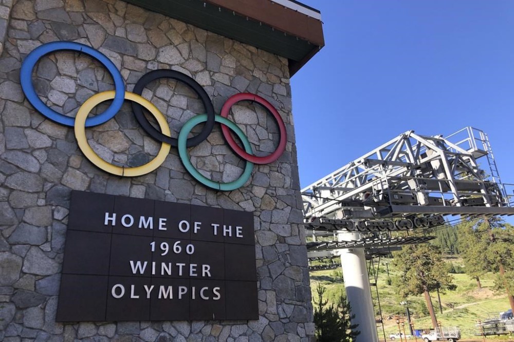 FILE - A sign marking the 1960 Winter Olympics is seen by a chairlift at what was then called Squaw Valley Ski Resort, July 9, 2020, in Olympic Valley, Calif. The U.S. government has joined a ski resort and others that have quit using a racist term for a Native American woman by renaming hundreds of peaks, lakes, streams and other geographical features on federal lands in the West and elsewhere. (AP Photo/Haven Daley, File)