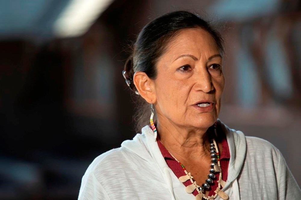 FILE - Secretary of the Interior Deb Haaland speaks at a news conference in Yellowstone National Park on Friday, July 8, 2022. The U.S. government has joined a ski resort and others that have quit using a racist term for a Native American woman by renaming hundreds of peaks, lakes, streams and other geographical features on federal lands in the West and elsewhere. Haaland in November declared the term derogatory and ordered members of the Board on Geographic Names, the Interior Department panel that oversees uniform naming of places in the U.S., and others to come up with alternatives. (Rachel Leathe/Bozeman Daily Chronicle via AP, File)