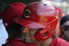 Cincinnati Reds' Kyle Farmer, right, is greeted by Donovan Solano, left, in the dugout after hitting a home run against the Chicago Cubs during the seventh inning of a baseball game, Thursday, Sept. 8, 2022, in Chicago. (AP Photo/David Banks)