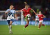 Slovenia's Lana Golob, left, and Wales' Ceri Holland battle for the ball during the Women's World Cup Qualifying, Group I soccer match at the Cardiff City Stadium, Cardiff, Wales, Tuesday Sept. 6, 2022. (Simon Galloway/PA via AP)