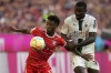 Bayern's Kingsley Coman, left, and Moenchengladbach's Marcus Thuram challenge for the ball during the German Bundesliga soccer match between FC Bayern Munich and Borussia Moenchengladbach in Munich, Germany, Saturday, Aug. 27, 2022. (AP Photo/Matthias Schrader)