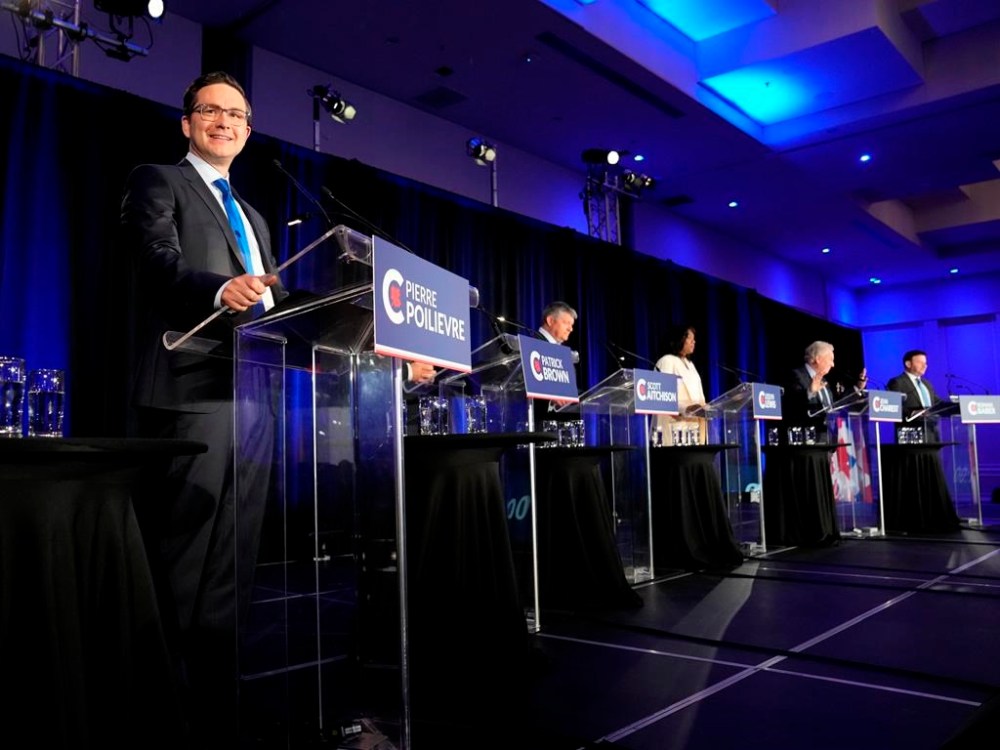 THE CANADIAN PRESS/Ryan Remiorz
Conservative leadership hopeful Pierre Poilievre, left, smiles as he takes part in the Conservative Party of Canada leadership debate on Wednesday.