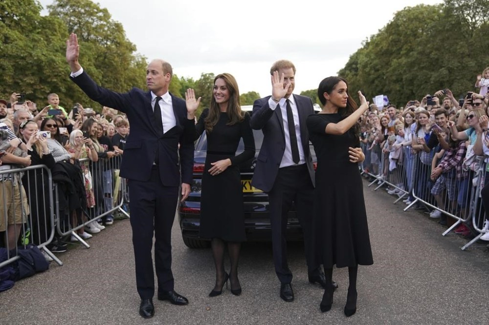 From left, Britain's Prince William, Prince of Wales, Kate, Princess of Wales, Prince Harry and Meghan, Duchess of Sussex wave to members of the public at Windsor Castle, following the death of Queen Elizabeth II on Thursday, in Windsor, England, Saturday, Sept. 10, 2022. (Kirsty O'Connor/Pool Photo via AP)