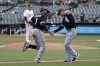 Chicago White Sox's Elvis Andrus (1) is congratulated by third base coach Joe McEwing after hitting a three-run home run off of Oakland Athletics pitcher Adrian Martinez, rear, during the second inning of a baseball game in Oakland, Calif., Saturday, Sept. 10, 2022. (AP Photo/Jeff Chiu)