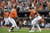Baltimore Orioles' Cedric Mullins is greeted by Adley Rutschman (35) after hitting a solo home run against Boston Red Sox starting pitcher Michael Wacha during the third inning of a baseball game, Saturday, Sept. 10, 2022, in Baltimore. (AP Photo/Terrance Williams)