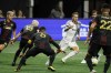 Toronto FC forward Federico Bernardeschi (10), third from right, drives through Atlanta United defenders in the box, drawing a penalty in the box which was overturned on review, during the first half of an MLS soccer match Saturday, Sept. 10, 2022, in Atlanta. (AP Photo/Bob Andres)