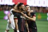 Atlanta United's Juan José Sánchez Purata, left, and Ronaldo Cisneros score Purata's goal against Toronto FC during the second half of an MLS soccer match Saturday, Sept. 10, 2022, in Atlanta. Atlanta won 4-2. (AP Photo/Bob Andres)