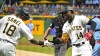 Pittsburgh Pirates' Rodolfo Castro (14) is greeted by Ben Gamel (18) as he heads to the dugout after hitting a solo home run off St. Louis Cardinals starting pitcher Jack Flaherty during the first inning of a baseball game in Pittsburgh, Saturday, Sept. 10, 2022. (AP Photo/Gene J. Puskar)