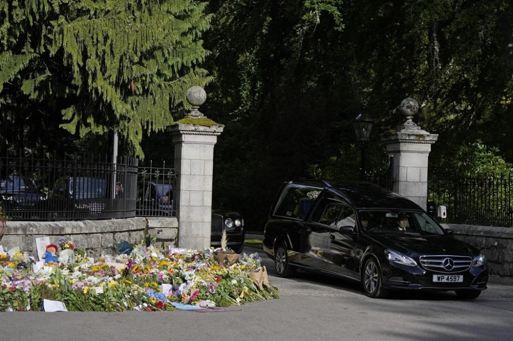 The coffin containing the body of Britain's Queen Elizabeth II leaves Balmoral Castle in Scotland, Sunday, Sept. 11, 2022. The Queen's coffin will be transported Sunday on a journey from Balmoral to the Palace of Holyroodhouse in Edinburgh, where it will lie at rest before being moved to London later in the week. (AP Photo/Alastair Grant)