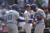 Los Angeles Dodgers' Justin Turner, right, is congratulated by Max Muncy after hitting a grand slam against the San Diego Padres in the seventh inning of a baseball game Sunday, Sept. 11, 2022, in San Diego. (AP Photo/Derrick Tuskan)