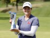 Ally Ewing holds the Champions Trophy after winning the LPGA Tour Kroger Queen City Championship golf tournament in Cincinnati, Sunday, Sept. 11, 2022. (AP Photo/Paul Vernon)