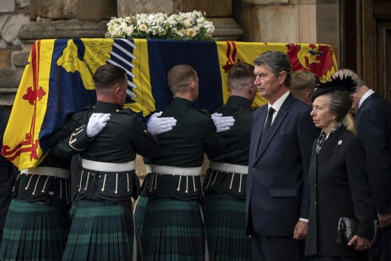 From second right, Vice Admiral Timothy Laurence and Princess Anne stand as the coffin of Queen Elizabeth II, completes its journey from Balmoral to the Palace of Holyroodhouse in Edinburgh. (Aaron Chown / Pool / The Associated Press)