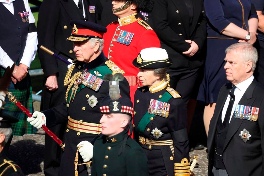 King Charles III, the Princess Royal and the Duke of York walk behind the hearse carrying the coffin of Britain's Queen Elizabeth II, in Edinburgh, Scotland, Monday Sept. 12, 2022. King Charles III will accompany the queen coffin on a solemn procession through the cobbled streets of the Scottish capital from the royal Palace of Holyroodhouse to St. Giles' Cathedral, where members of the public will be able to pay their respects. (Phil Noble/pool photo via AP)