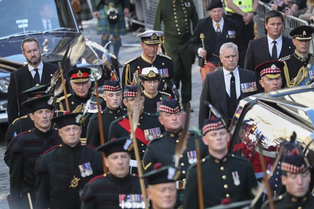 The procession with the coffin of Queen Elizabeth II, followed by, from left, King Charles III, Princess Anne, Prince Andrew, and Prince Edward, heads up the Royal Mile to St Giles' Cathedral in Edinburgh, Monday, Sept. 12, 2022. Britain's longest-reigning monarch who was a rock of stability across much of a turbulent century, died Thursday Sept. 8, 2022, after 70 years on the throne. She was 96. (AP Photo/Scott Heppell)