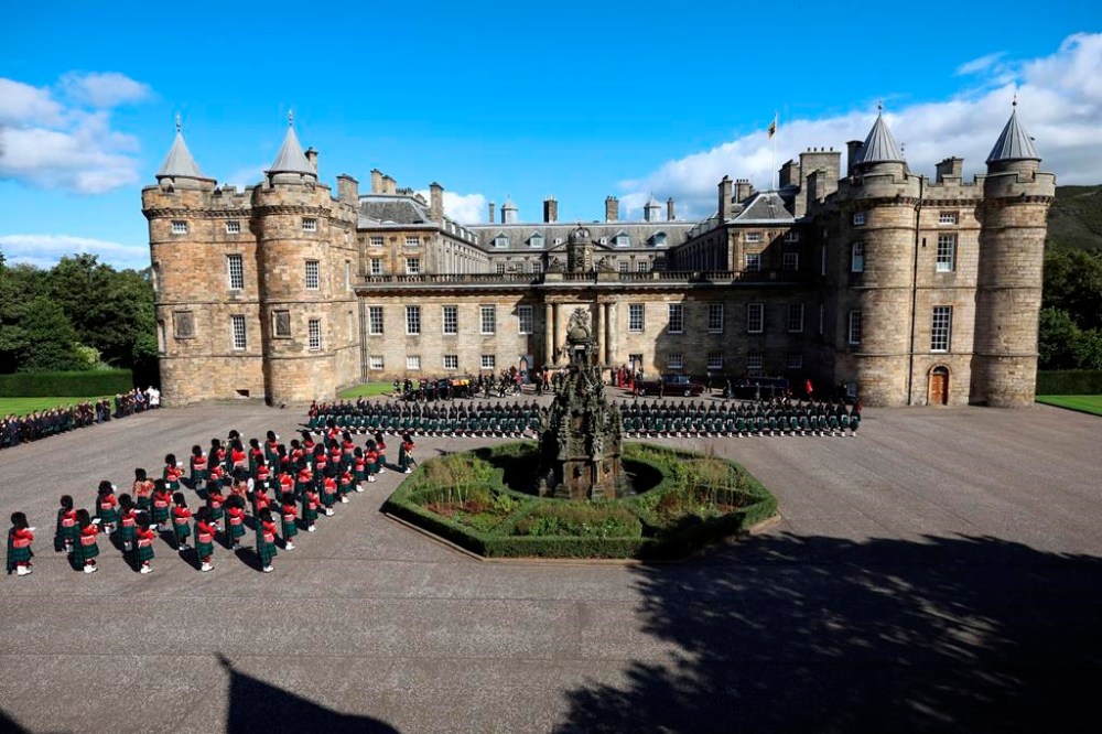 The hearse carrying the coffin of Britain's Queen Elizabeth departs the Palace of Holyroodhouse, following the death of Britain's Queen Elizabeth, Edinburgh, Scotland, Monday Sept. 12, 2022. King Charles III will accompany the queen coffin on a solemn procession through the cobbled streets of the Scottish capital from the royal Palace of Holyroodhouse to St. Giles' Cathedral, where members of the public will be able to pay their respects. (Phil Noble/pool photo via AP)