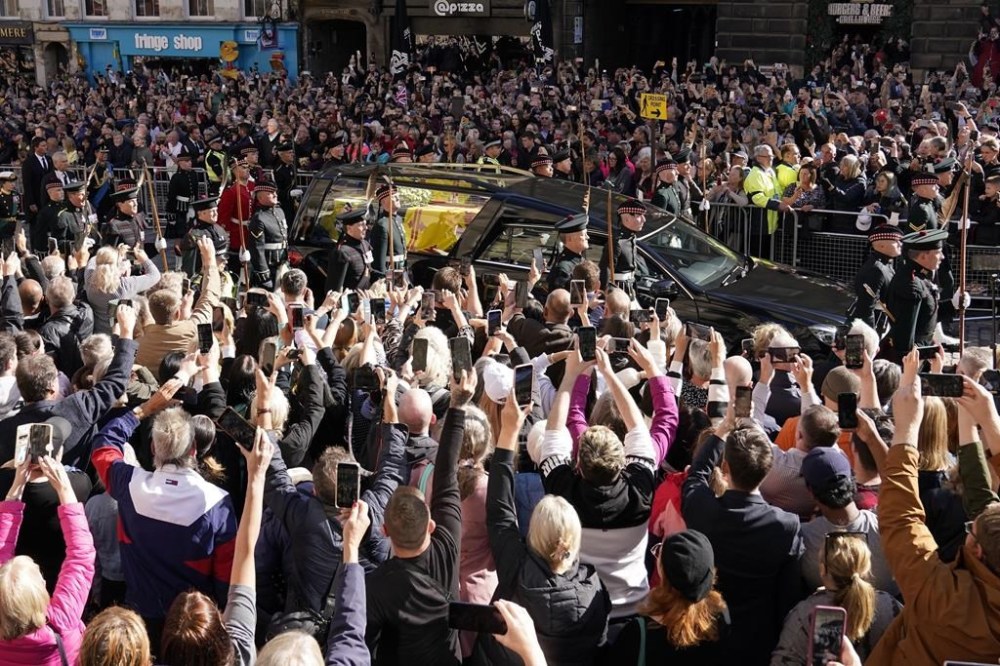 King Charles III and members of the Royal family joins the procession of Queen Elizabeth II's coffin from the Palace of Holyroodhouse to St Giles' Cathedral, in Edinburgh, Monday, Sept. 12, 2022. King Charles arrived in Edinburgh on Monday to accompany his late mother’s coffin on an emotion-charged procession through the historic heart of the Scottish capital to the cathedral where it will lie for 24 hours to allow the public to pay their last respects. (Owen Humphreys/Pool Photo via AP)