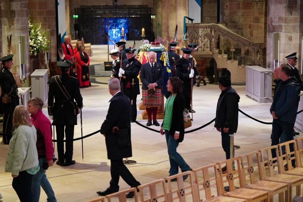 Britain's King Charles III, center, and other members of the royal family hold a vigil at the coffin of Queen Elizabeth II at St Giles' Cathedral, Edinburgh, Scotland, Monday Sept. 12, 2022, as members of the public walk past. (Jane Barlow/Pool via AP)