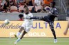 New England Revolution defender Andrew Farrell (2) kicks the ball away as Houston Dynamo forward Darwin Quintero Jr. (23) defends during the first half of an MLS soccer match Tuesday, Sept. 13, 2022, in Houston. (AP Photo/Michael Wyke)