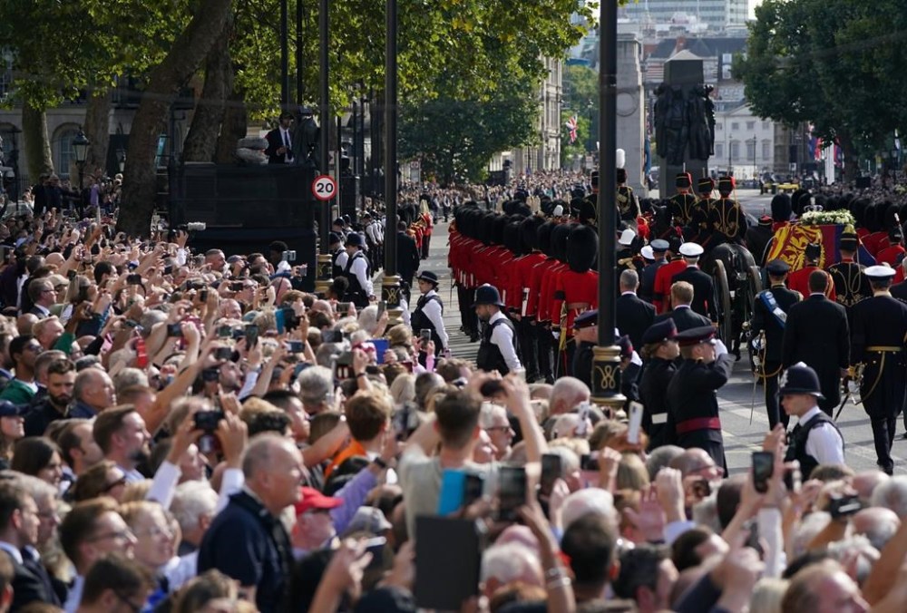 The coffin of Queen Elizabeth II, draped in the Royal Standard with the Imperial State Crown placed on top, is carried on a horse-drawn gun carriage of the King's Troop Royal Horse Artillery, during a procession for the Lying-in State of Queen Elizabeth II from Buckingham Palace to Westminster Hall in London, Wednesday, Sept. 14, 2022. The Queen will lie in state in Westminster Hall for four full days before her funeral on Monday Sept. 19. (Kirsty O'Connor/Pool Photo via AP)