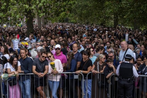 FILE - People wait in line to lay flowers for Queen Elizabeth II in front of Buckingham Palace, in London, Sept. 11, 2022. Because she reigned and lived for so long, Queen Elizabeth II's death was a reminder that mortality and the march of time are inexorable. (AP Photo/Nariman El-Mofty, File)