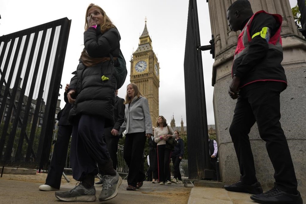 People leave Westminster Palace after paying their respects, during the Lying-in State, at Westminster Hall in London, Thursday, Sept. 15, 2022. The Queen will lie in state in Westminster Hall for four full days before her funeral on Monday Sept. 19. (AP Photo/Markus Schreiber)
