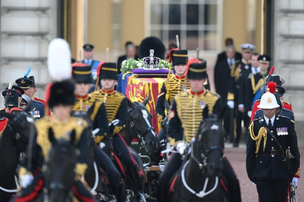 A view of the coffin of Queen Elizabeth II, adorned with a Royal Standard and the Imperial State Crown and pulled by a Gun Carriage of The King's Troop Royal Horse Artillery, during a procession from Buckingham Palace to Westminster Hall in London, Wednesday, Sept. 14, 2022. The Queen will lie in state in Westminster Hall for four full days before her funeral on Monday Sept. 19. (Daniel Leal/Pool Photo via AP)
