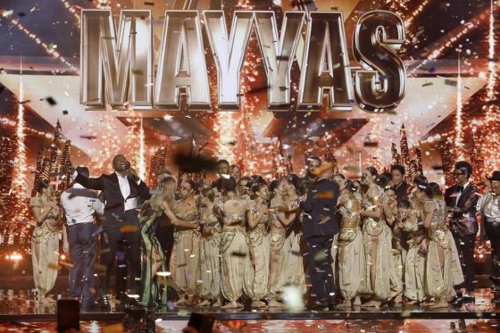 Host Terry Crews, left, in suit, with members of the female Lebanese dance troupe Mayyas after winning 'America's Got Talent,' Wednesday. (Trae Patton / NBC via The Associated Press)