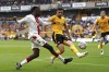 Southampton's Joe Aribo, left, attempts a cross towards goal during the English Premier League soccer match between Wolverhampton Wanderers and Southampton, at Molineux Stadium, Wolverhampton, England, Saturday Sept. 3, 2022. (Tim Goode/PA via AP)