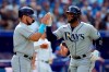 Tampa Bay Rays third baseman Isaac Paredes (17) congratulates teammate Yandy Diaz (21) after scoring on a three run home-run by Diaz during second inning MLB baseball action against the Toronto Blue Jays, in Toronto, Thursday, Sept. 15, 2022. THE CANADIAN PRESS/Frank Gunn