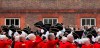 FILE - Chelsea Pensioners raise their hats as they offer three cheers for Britain's Queen Elizabeth II, as they take part in their Founders Day parade in London, Thursday, June 7, 2012. The Royal Hospital Chelsea has been caring for Britain's veteran soldiers since its foundation by King Charles II in 1682, the veterans known as Chelsea Pensioners are easily identifiable by their traditional red coats. (AP Photo/Alastair Grant, File)