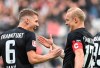 Frankfurt's Kristijan Jakic, left, and his teammate Sebastian Rode, right, celebrate during the German Bundesliga soccer match between VfB Stuttgart and Eintracht Frankfurt in Stuttgart, Germany, Saturday, Sept. 17, 2022. (Marijan Murat /dpa via AP)