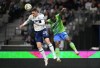 Vancouver Whitecaps' Jake Nerwinski, left, gets his head on a pass intended for Seattle Sounders' Nouhou Tolo during the first half of an MLS soccer game in Vancouver, on Saturday, September 17, 2022. THE CANADIAN PRESS/Darryl Dyck