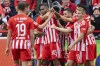 Union's scorer Jordan Siebatcheu, center, and his teammates celebrate the opening goal during the Bundesliga soccer match between 1. FC Union Berlin and Vfl Wolfsburg in Berlin, Germany, Sunday, Sept. 18, 2022. (Andreas Gora/dpa via AP)