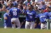 Kansas City Royals' Nate Eaton (18) is welcomed to the dugout by Salvador Perez (13) after scoring on a double by Drew Waters in the second inning of a baseball game against the Boston Red Sox, Sunday, Sept. 18, 2022, in Boston. (AP Photo/Steven Senne)