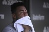 Colorado Rockies catcher Elias Diaz wipes his face in the dugout during the fourth inning of a baseball game against the Chicago Cubs, in Chicago, Sunday, Sept. 18, 2022. (AP Photo/Matt Marton