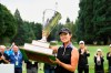 Andrea Lee, of the United States, holds the championship trophy after winning the LPGA Portland Classic golf tournament in Portland, Ore., Sunday, Sept. 18, 2022. (AP Photo/Troy Wayrynen)