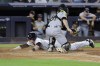 New York Yankees' Harrison Bader scores ahead of the tag by Pittsburgh Pirates catcher Jason Delay (61) during the fifth inning of a baseball game Tuesday, Sept. 20, 2022, in New York. (AP Photo/Jessie Alcheh)